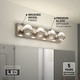 Modern bathroom vanity light fixture with four round glass diffusers, a brushed nickel finish, and integrated LED technology. Text highlights features: “Brushed nickel finish,” “Premium glass diffuser,” and “5 years warranty.”.