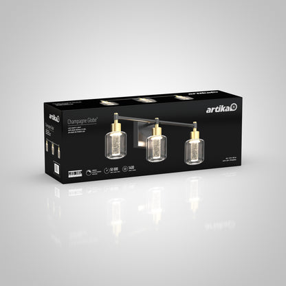 A box of Artika Champagne Globe bathroom vanity light, with gold and black three-light fixture, cylindrical glass shades, product details, and Artika branding shown on the packaging.