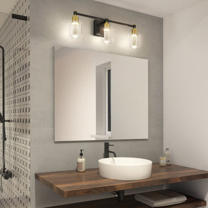 Modern bathroom featuring a round white vessel sink on a wooden countertop, rectangular mirror above, Artika’s Champagne Globe bathroom vanity light with three bulbs, soap dispensers, and a partial view of the shower area.