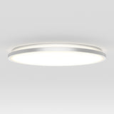 A modern, circular ceiling light fixture with a sleek, minimalist design, mounted on a white ceiling and emitting a bright, even glow.