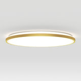 A modern circular ceiling light with a gold outer rim and a glowing white center, mounted on a plain white ceiling.