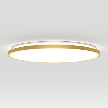 A modern circular ceiling light with a gold outer rim and a glowing white center, mounted on a plain white ceiling.