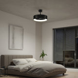 A modern bedroom with a gray bed, white bedding, a small plant, abstract wall art, and a large window with blinds. A contemporary black ceiling fan with a light is mounted on the ceiling.