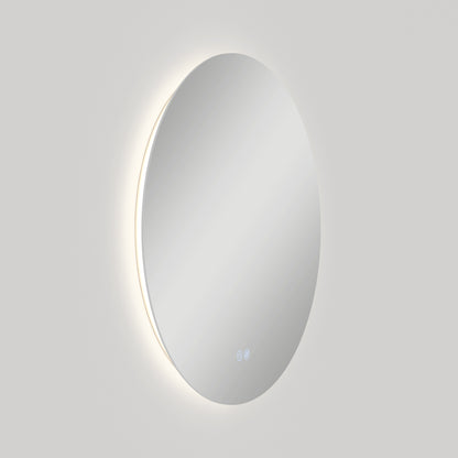 The Artika Raya 24 in. LED mirror features a soft backlight and two touch icons near the bottom edge, glowing against a plain light gray background. This wall-mounted mirror includes 3 CCT options and a built-in defogger.