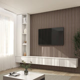 A modern living room with a wall-mounted TV on a wooden slat accent wall, white floating console, built-in shelves with decor, a white coffee table, and sunlight streaming through sheer curtains.