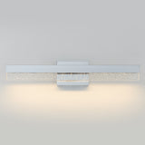 A modern wall-mounted light fixture with a rectangular design, featuring a frosted glass panel speckled with tiny bubbles, emitting a soft, warm glow against a light gray wall.