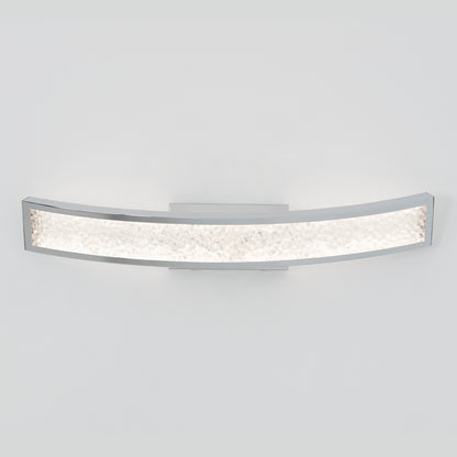 The Artika Glitter LED bathroom vanity light features a modern curved design with a chrome frame and textured crystalline surface, shown glowing brightly against a light gray background.