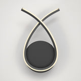 A modern wall lamp with two curved, black arms crossing at the top, each outlined with a soft white LED light, mounted on a circular black base against a plain white background.