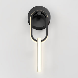 The Artika Catena modern LED wall sconce 5 CCT features a black circular base and elongated oval LED light, providing soft accent lighting, shown against a plain white background.