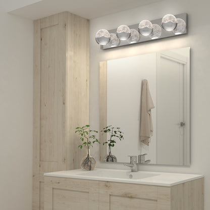 Modern bathroom with light wood cabinets, white countertop and sink, large mirror, two small potted plants, towel on the wall, and an Artika Oracle LED bathroom vanity light mounted above the mirror.