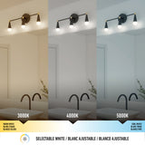 A bathroom light fixture above a mirror displays three lighting tones: warm white (3000K), neutral white (4000K), and cool white (5000K). Each tone illuminates the sink area differently. Text in English, French, and Spanish.