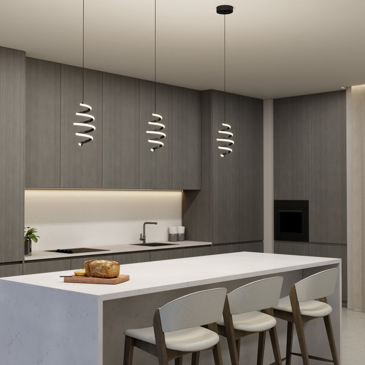 Modern kitchen with gray cabinets, white island countertop, three white bar stools, built-in oven, and Artika Chorus 1-light LED pendant 5 CCT for decorative lighting; loaf of bread and knife on a wooden board.