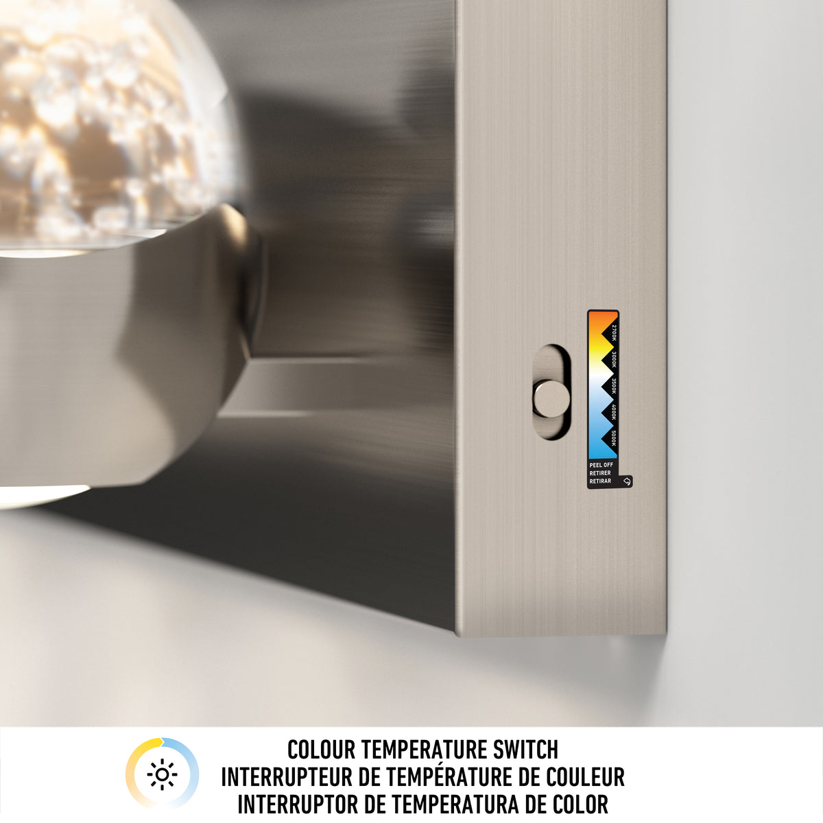 Close-up of a metallic light fixture with a color temperature switch, showing a slider next to a gradient label from warm orange to cool blue. Text below reads: Colour Temperature Switch in three languages.