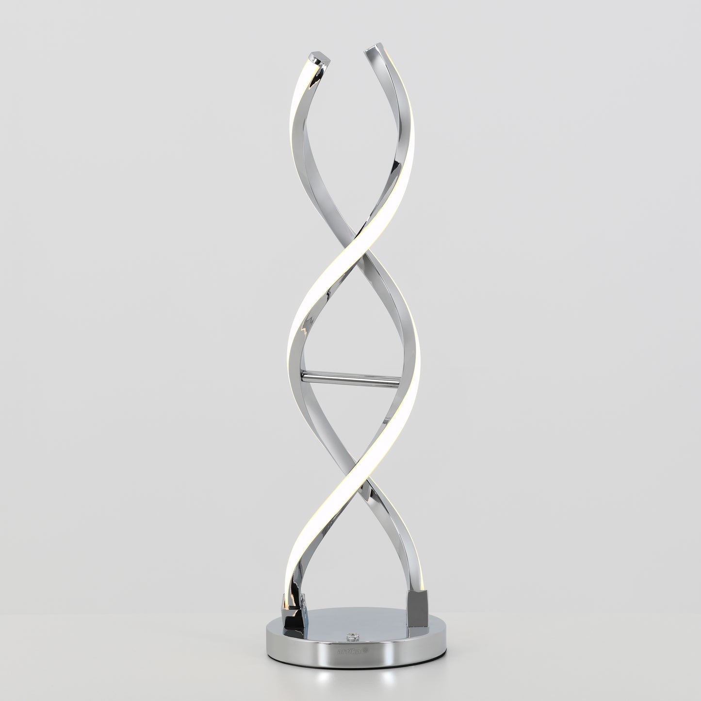 The Artika Swirl LED table lamp features a twisted double-helix metal design and integrated LED light, resting on a round chrome-finished base, displayed against a plain light background.