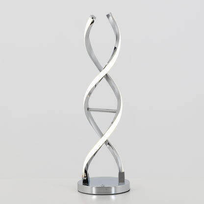 The Artika Swirl LED table lamp features a twisted double-helix metal design and integrated LED light, resting on a round chrome-finished base, displayed against a plain light background.