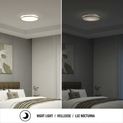A modern bedroom showcases the Artika Hemisphere 15 in. LED flush mount light 5 CCT, shown with adjustable brightness: bright white on the left and dim night light on the right. Text below reads “Night Light / Veilleuse / Luz Nocturna.”.