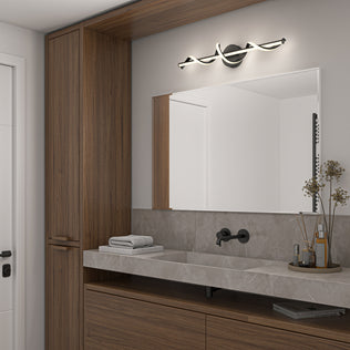 Modern bathroom with wood cabinets, gray countertop, black faucet, and a large mirror. Above the mirror is the Artika Coda 27-in Integrated LED 5-CCT Vanity Light Bar. Towels and a vase with dried flowers add cozy touches to the counter.