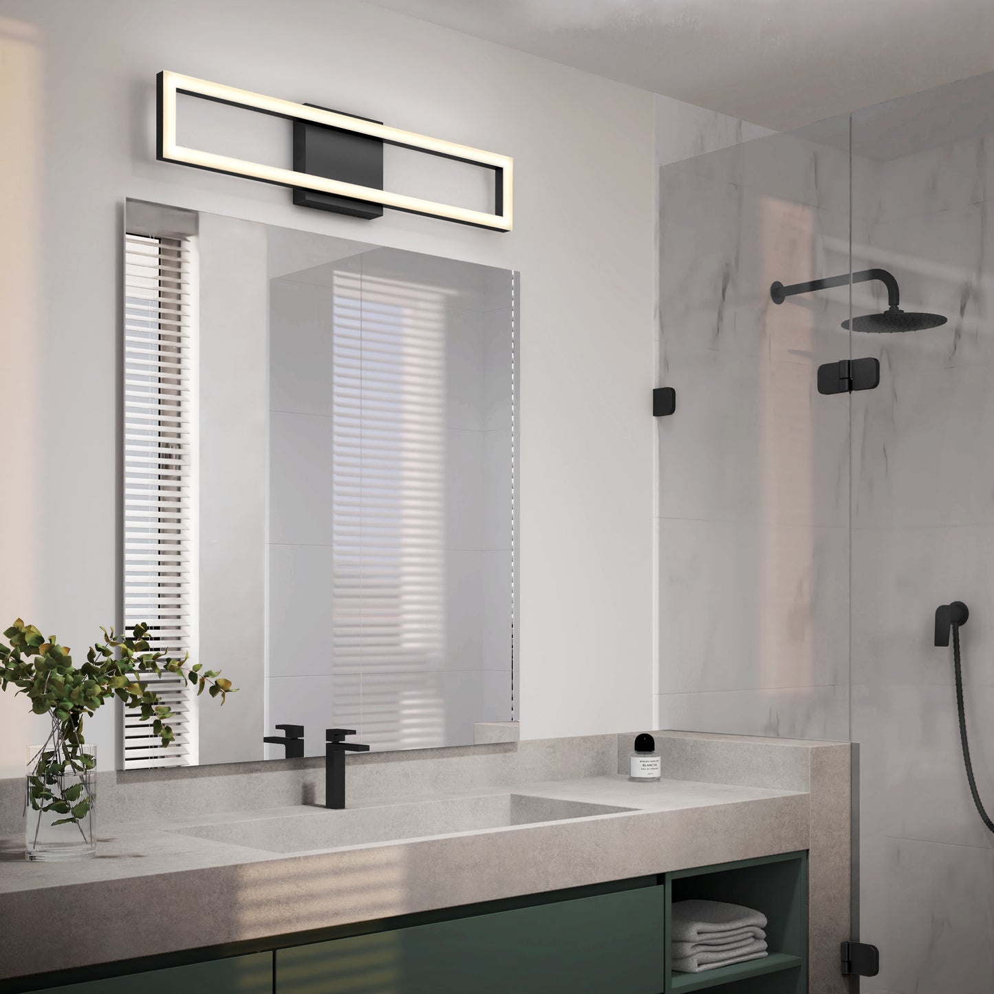 Modern bathroom with a large mirror, Artika Dover modern LED vanity light above, black fixtures, a sink with concrete countertop, glass shower featuring black showerhead, and a small vase with greenery on the counter.