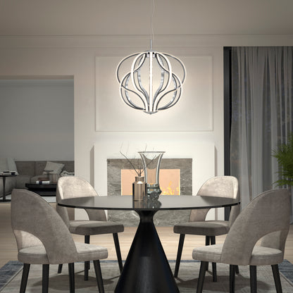 Modern dining room with a round black table, four gray upholstered chairs, a decorative centerpiece, fireplace, and the Artika Meridian LED pendant light hanging above. Cozy living area can be seen in the background.