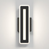 A modern rectangular wall sconce with a black central panel and a white illuminated border, mounted on a grey wall and casting soft light outward.