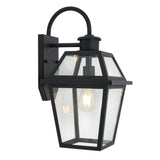 A black outdoor wall lantern with a rectangular base and clear glass panels, showcasing an exposed bulb inside. The fixture has a classic, geometric design and is mounted to the wall with a curved arm.