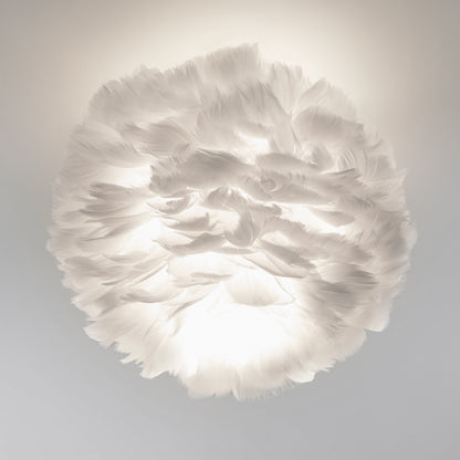 The Artika Plume LED flush mount light features a white, feathered design that softly diffuses light through its layered feathers, evoking a cloud-like ambiance in any room.