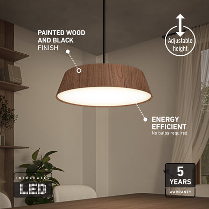The Artika Dunham LED Pendant 5 CCT, with a wood and black finish, hangs over a dining table. Its adjustable height, integrated LED (no bulbs needed), energy efficiency, and 5-year warranty are noted. Decor includes shelves and a plant.