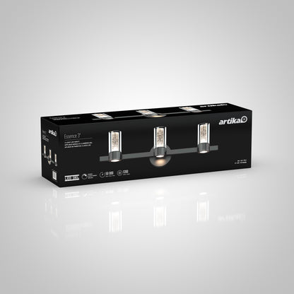 A rectangular black and gray Artika box showing the Novello modern LED bathroom vanity light, with product details and LED lifespan info on the packaging.