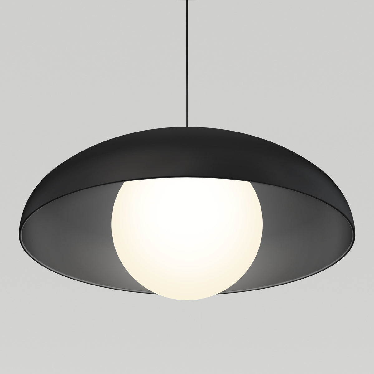 A modern pendant light with a black, dome-shaped shade and a glowing white spherical bulb, suspended by a thin black cord against a plain light gray background.