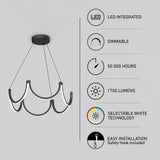 Modern black and white LED chandelier with scalloped design, accompanied by icons and text listing features: LED integrated, dimmable, 50,000 hours lifespan, 1700 lumens, selectable white technology, and easy installation.
