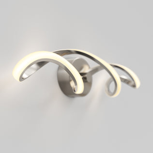 The Artika Swirl LED bathroom vanity light features three looping, curved metal arms emitting a soft white glow, wall-mounted on a round base.