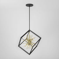 The Artika Nebula 6-light pendant features a gold starburst design within a black open cube frame, suspended by a black rod, shown against a plain white background.