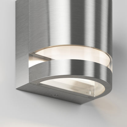 Close-up of Artika’s Valor Round LED wall light, showcasing its curved design, brushed finish, and soft diffused glow.