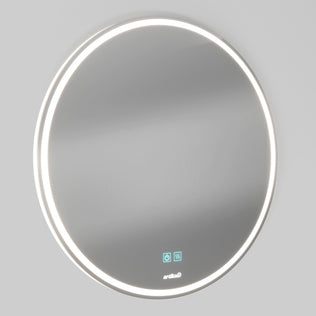 The Artika Mateo 28 in. LED mirror 3 CCT with defogger is a round, wall-mounted mirror featuring a glowing LED light border and two blue touch control icons at the bottom, shown on a plain light gray background.