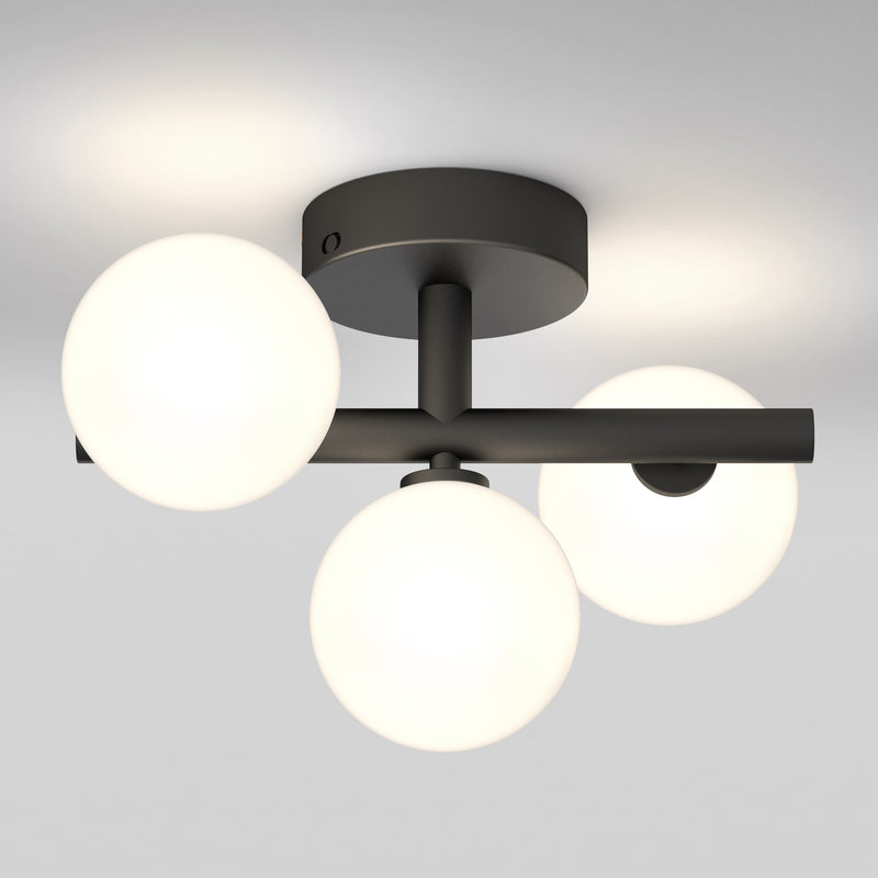 Artika’s Bloom LED flush mount features a black base, three frosted globes, and tunable white customizable illumination.
