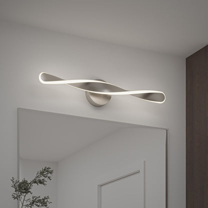 The Artika Finley LED modern bathroom vanity light 3 CCT offers a stylish, twisted design and soft white illumination above a rectangular mirror, complementing minimalist white walls and dark wood accents.