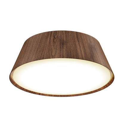 The Artika Dunham 15 in. LED flush mount light features a wood grain finish and glowing white center, viewed from below against a white background. Selectable with 5 CCT settings for customizable lighting.