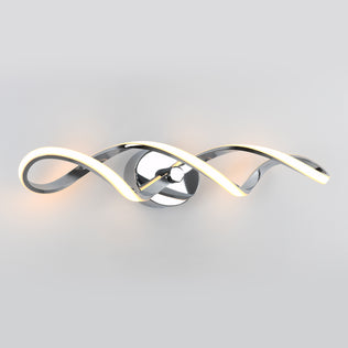 The Artika Swirl modern LED bathroom vanity light features two intertwining chrome arms with integrated LEDs on a round reflective base, shown against a plain light gray background.