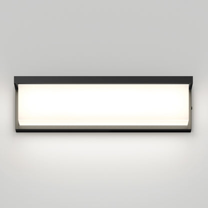 The Artika Bristol modern LED bathroom vanity light 3 CCT is a rectangular, wall-mounted fixture with a black frame that casts a soft white glow against a plain light gray wall.