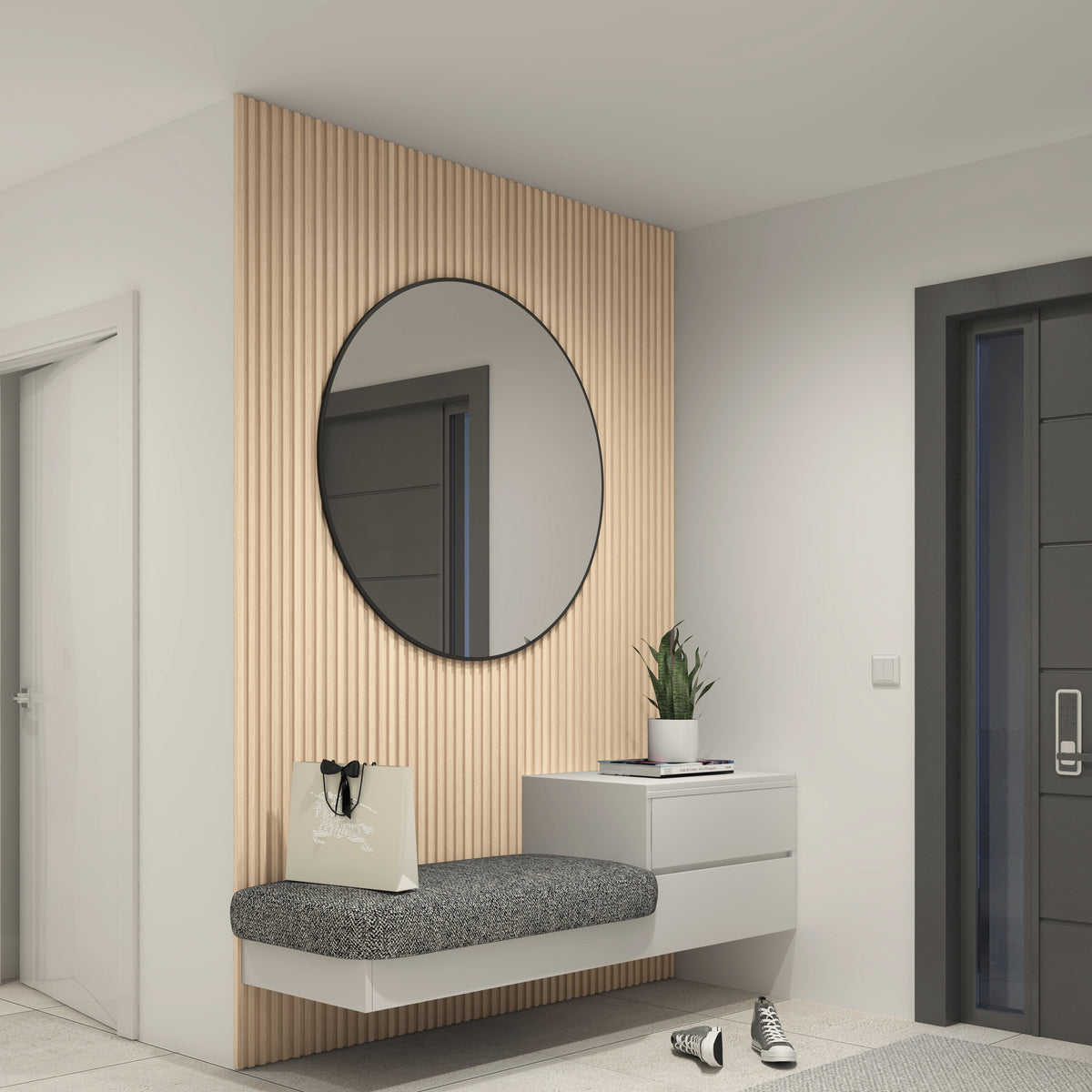 A modern entryway with a round mirror on a wood-paneled wall, a gray cushioned bench, a white drawer unit with a potted plant, a shopping bag, and a pair of sneakers on the floor.