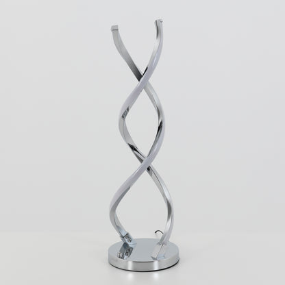 The Artika Swirl LED table lamp features two intertwined, curved chrome light strips on a round base, shown against a plain white background.