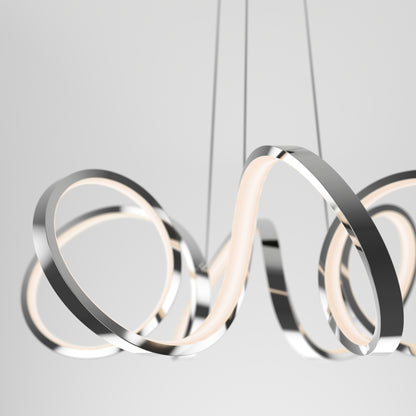 The Artika Swirl Ribbon LED pendant light features modern, abstract intertwined chrome loops suspended by slim wires. Its loops emit a soft, warm glow for a sleek and artistic centerpiece.