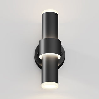 The Artika Dani modern LED indoor-outdoor wall light 5 CCT features two cylindrical fixtures on a circular base, with up and down lighting that emits soft white light, perfect for brightening light-colored walls.
