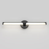 A modern, horizontal wall-mounted LED light fixture with a black circular base and sleek, tubular design, emitting soft, even white light against a plain gray background.