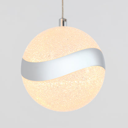 The Artika Wavey 5-light LED pendant features a spherical, textured glowing surface with a metallic silver wave band around the center, suspended by a cord against a simple background.