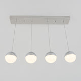 A modern ceiling light fixture with four spherical, glowing bulbs hanging in a row from a rectangular metallic base by thin wires, against a plain white background.