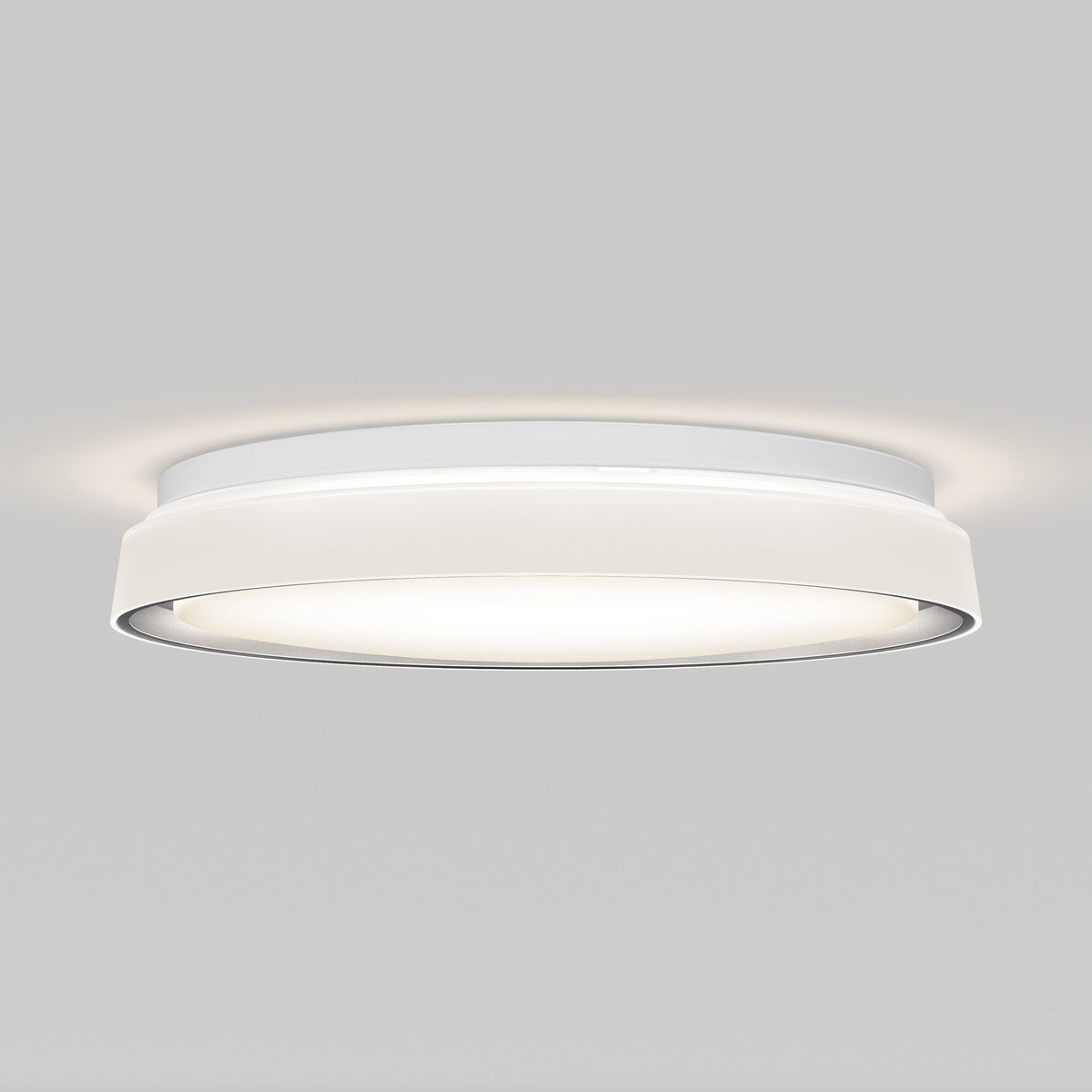 A modern, round, white ceiling light fixture emits a soft, even glow against a plain light gray background.