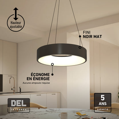 An Aiden LED pendant light with a circular, matte black finish and adjustable height hangs above a kitchen table.