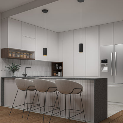 A modern kitchen with white cabinets, gray countertop, and three beige bar stools. Two Artika Alton mini LED pendant lights hang over the counter. A stainless steel fridge is on the right; shelves with jars and a plant are on the left.