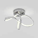 Modern ceiling light fixture with three curved LED light loops and a shiny chrome base, mounted on a white ceiling, emitting soft white light.